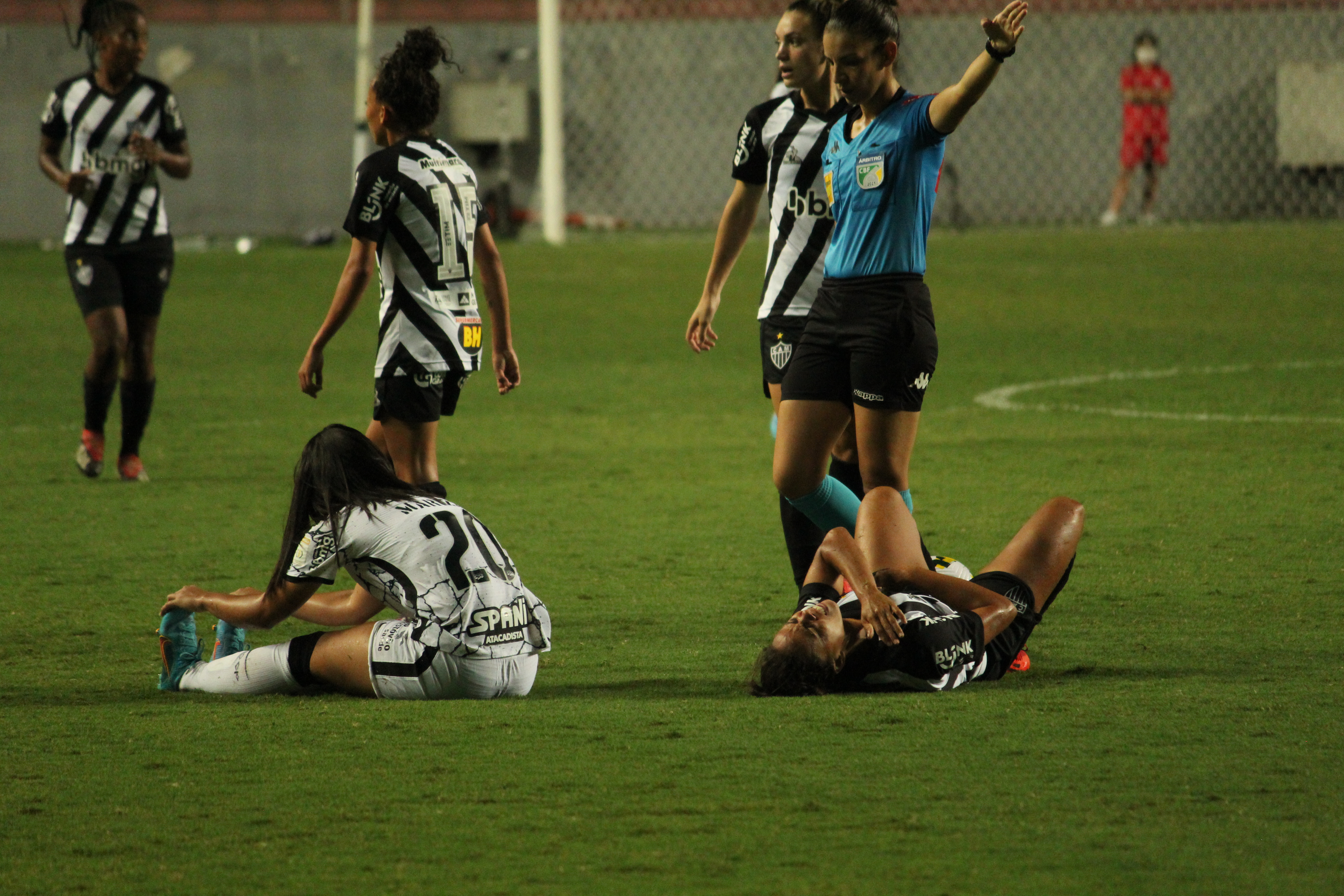 Jogadoras de Corinthians e Galo caídas no chão após choque.